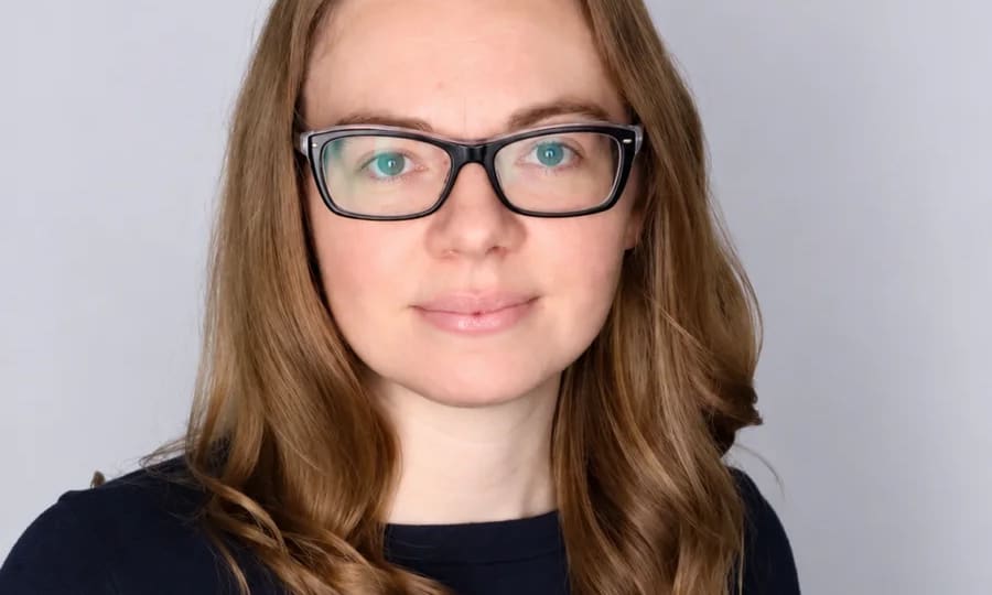 Portrait of Marquette doctoral researcher Karen Wurzel wearing glasses.
